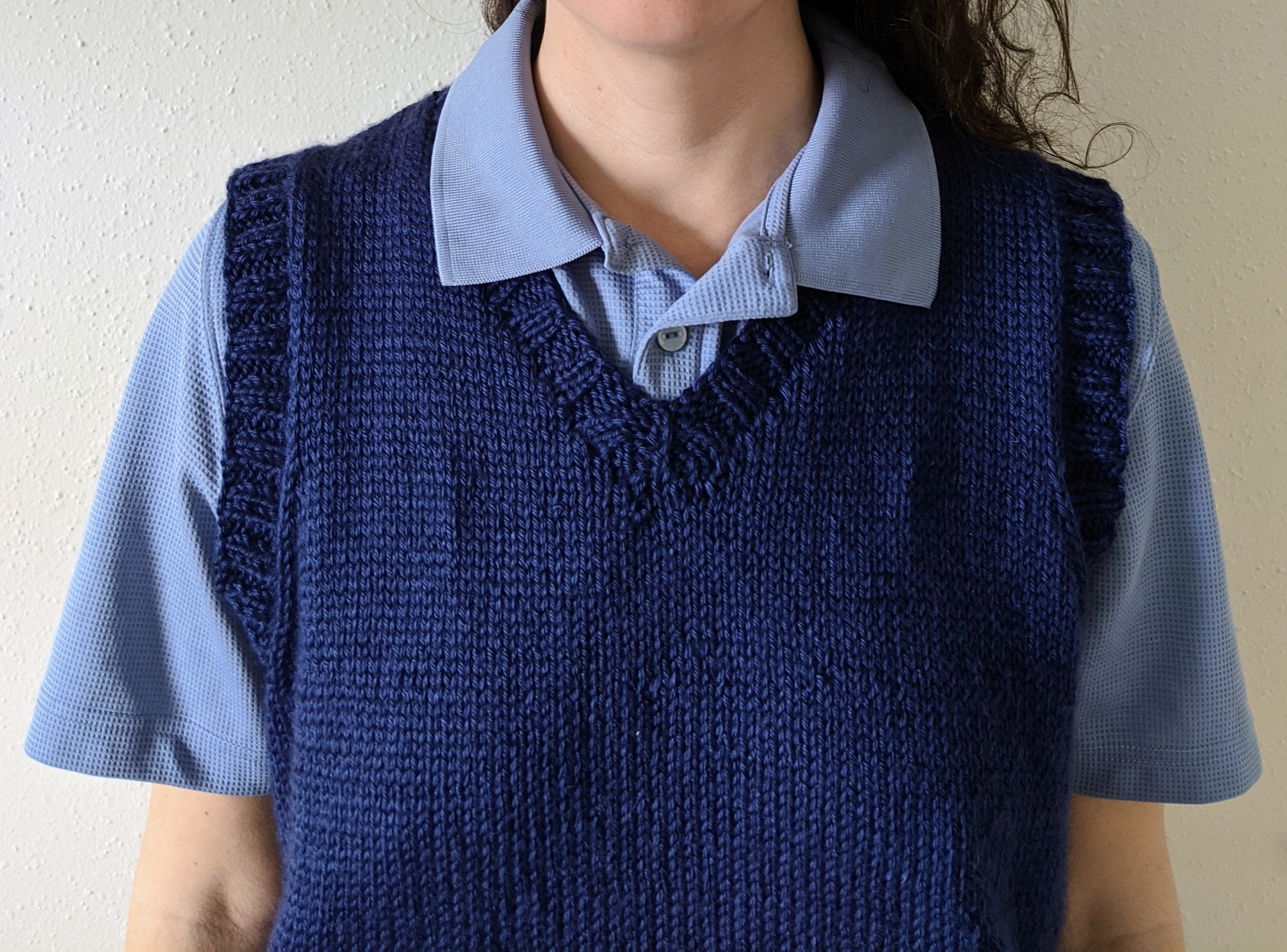 photo of blue knitted vest