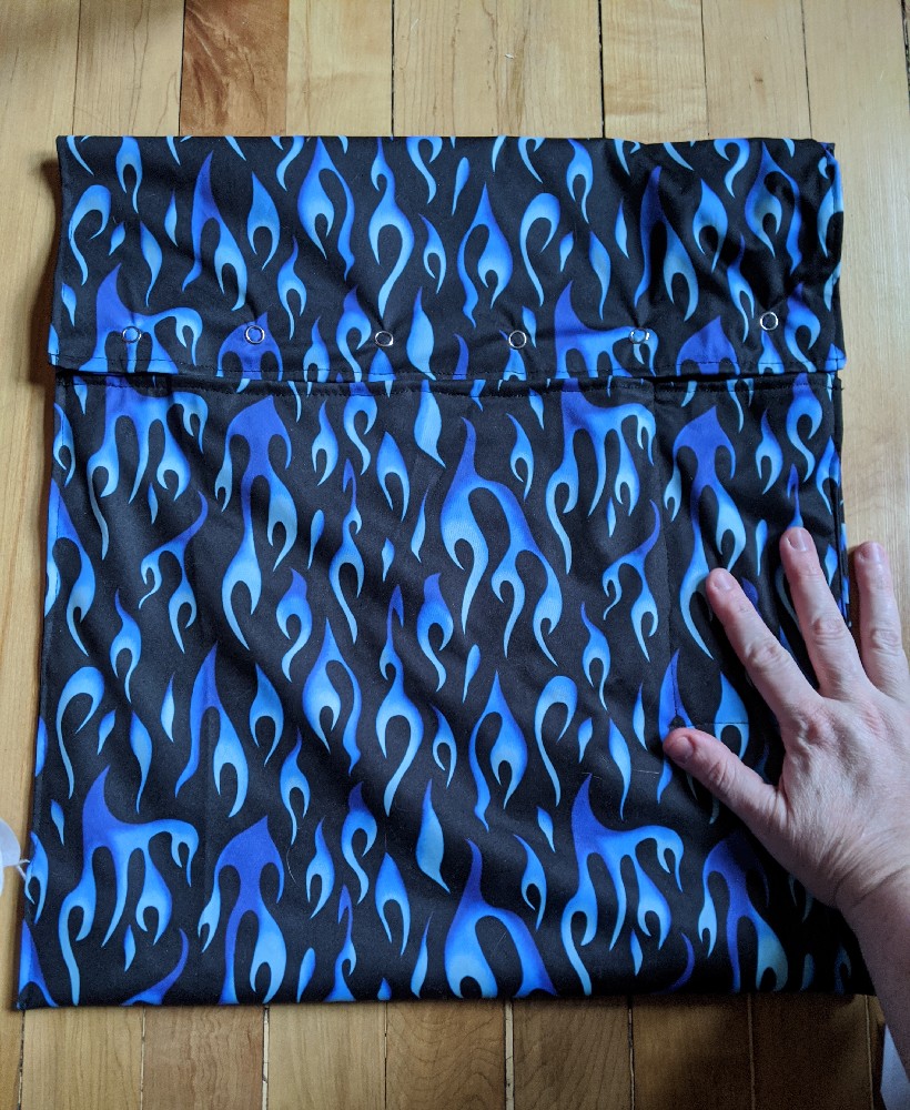 A black sewn bag with blue flames