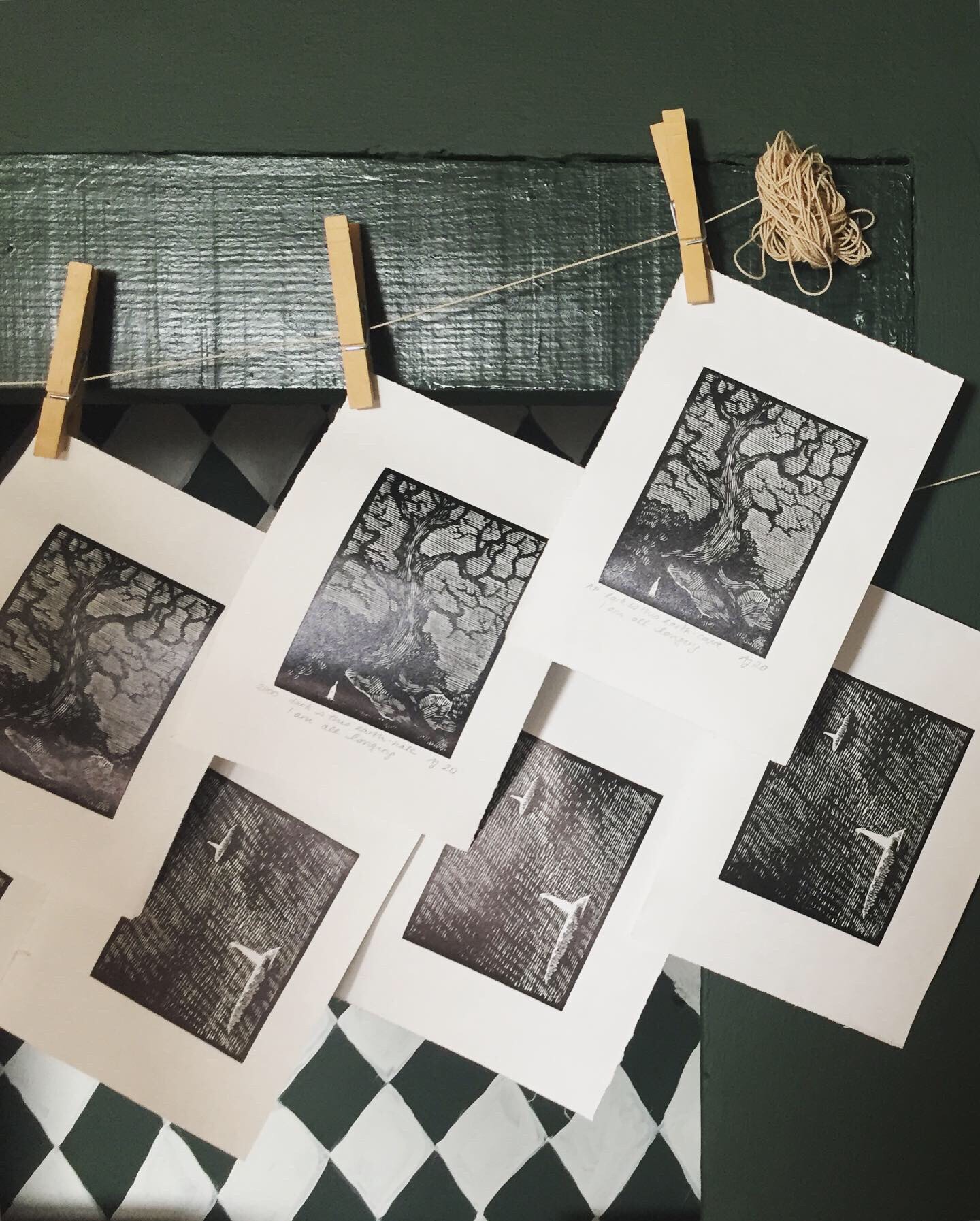 Wood engravings hanging on clothes line